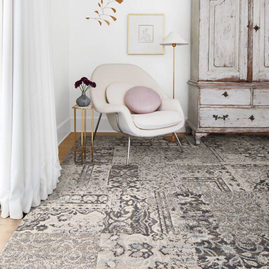 Corner sitting nook with FLOR Reoriented area rug shown in Grey